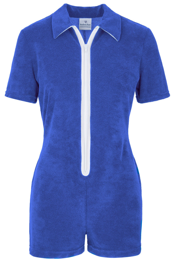 A royal blue short-sleeve romper with a white zipper and white piping details, shown against a plain white background.